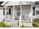 Close up of the covered front porch with swing and seating at 506 Currin St, Durham, NC 27703