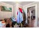 Hallway with many clothes and household items with access to other rooms and wood floor throughout at 506 Currin St, Durham, NC 27703