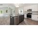 Modern kitchen with stainless steel appliances, white cabinets, and a gray kitchen island with a sink at 510 Branch St, Rocky Mount, NC 27801