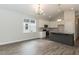 Open concept kitchen with a granite countertop island, stainless steel appliances, and lots of natural light at 510 Branch St, Rocky Mount, NC 27801