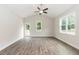 Bright living room features luxury vinyl plank flooring, a ceiling fan, and access to an outdoor deck at 510 Branch St, Rocky Mount, NC 27801