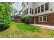 View of a well-maintained backyard featuring green grass, mature landscaping, and a home exterior at 5123 Richland Dr, Raleigh, NC 27612