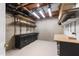 Unfinished basement features concrete walls, storage racks, and workbench for a customizable space at 5123 Richland Dr, Raleigh, NC 27612