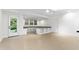 Bright basement space featuring a built-in desk area, and light colored wood-look floors at 5123 Richland Dr, Raleigh, NC 27612