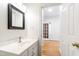 Bright bathroom featuring a white vanity with a black framed mirror at 5123 Richland Dr, Raleigh, NC 27612