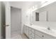 Bright bathroom with double sink vanity, classic white cabinets and ample counter space at 5123 Richland Dr, Raleigh, NC 27612