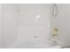 Clean white tiled bathtub with a gold faucet and shower head at 5123 Richland Dr, Raleigh, NC 27612