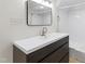 Modern bathroom vanity with a sleek mirror, faucet and sink at 5123 Richland Dr, Raleigh, NC 27612