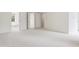 A large bedroom space with two doors, soft carpet and neutral paint at 5123 Richland Dr, Raleigh, NC 27612