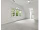 Bright bedroom featuring a large window, a ceiling fan and light gray carpeting at 5123 Richland Dr, Raleigh, NC 27612
