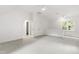 Bright bedroom with a ceiling fan, a light gray carpet and access to another room at 5123 Richland Dr, Raleigh, NC 27612