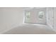 Bedroom featuring carpeted floors, backyard views and a closet at 5123 Richland Dr, Raleigh, NC 27612