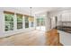 Bright breakfast nook with hardwood floors and multiple windows overlooking the backyard at 5123 Richland Dr, Raleigh, NC 27612