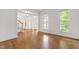Open-concept entryway featuring hardwood floors, staircase, and transom windows allowing ample natural light at 5123 Richland Dr, Raleigh, NC 27612