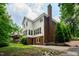 Two-story home with a brick chimney, manicured backyard, and well-maintained lawn at 5123 Richland Dr, Raleigh, NC 27612