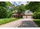 Beautiful brick home with an attached two-car garage, complemented by mature trees and a large, well-maintained lawn at 5123 Richland Dr, Raleigh, NC 27612