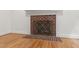 Close up shot of a charming brick fireplace with a decorative screen at 5123 Richland Dr, Raleigh, NC 27612