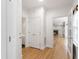 Hallway with access to various rooms and hardwood flooring at 5123 Richland Dr, Raleigh, NC 27612