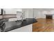Granite countertops and stainless faucet complement the open kitchen with hardwood floors at 5123 Richland Dr, Raleigh, NC 27612