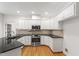 Modern kitchen with granite countertops, stainless steel appliances, and white cabinets at 5123 Richland Dr, Raleigh, NC 27612