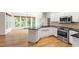 Bright kitchen with stainless appliances, granite countertops, island and large windows at 5123 Richland Dr, Raleigh, NC 27612