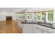 Open living space features hardwood floors, fireplace, and kitchen with granite countertops at 5123 Richland Dr, Raleigh, NC 27612