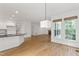 Open-concept living space with hardwood floors, connecting the kitchen and living areas at 5123 Richland Dr, Raleigh, NC 27612