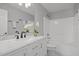 Neutral bathroom features white marble vanity, large mirror, and shower-tub combo at 5300 Roan Mountain Pl, Raleigh, NC 27613