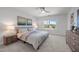 Neutral bedroom features neutral colored walls, neutral carpet, ceiling fan, and a large window at 5300 Roan Mountain Pl, Raleigh, NC 27613