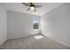 Bright and open bedroom with neutral carpet, ceiling fan, and a large window at 5300 Roan Mountain Pl, Raleigh, NC 27613