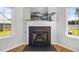 Elegant fireplace with a decorative mantel and large windows for ample natural light at 5300 Roan Mountain Pl, Raleigh, NC 27613