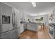 Bright kitchen features stainless steel appliances, white cabinetry, and an eat-in dining area with backyard views at 5300 Roan Mountain Pl, Raleigh, NC 27613