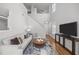 Spacious living room featuring a staircase, high ceilings and an entertainment area with a television at 5300 Roan Mountain Pl, Raleigh, NC 27613