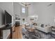 Bright living room with high ceilings, fireplace, and large windows that provide natural light at 5300 Roan Mountain Pl, Raleigh, NC 27613