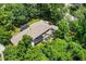 Aerial view highlighting the home's setting amidst mature trees and gardens for private outdoor living at 5301 Thayer Dr, Raleigh, NC 27612