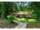 Exterior shot of the home with visible house number and charming front garden at 5301 Thayer Dr, Raleigh, NC 27612