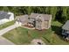 Overhead shot of craftsman home with three car garage, complemented by lush landscaping at 543 Allessandra Dr, Clayton, NC 27527