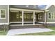 Charming covered back porch featuring brick trim, ceiling fans, and access to a well-manicured lawn at 543 Allessandra Dr, Clayton, NC 27527