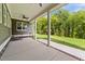 Inviting covered back porch with ceiling fan and view of the lush green backyard at 543 Allessandra Dr, Clayton, NC 27527