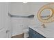 A powder room with a blue vanity, white countertops, and a gold mirror at 543 Allessandra Dr, Clayton, NC 27527