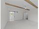 Bedroom boasts exposed ceiling beams, a sliding barn door, and neutral carpet at 543 Allessandra Dr, Clayton, NC 27527
