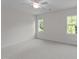 Bright bedroom features natural light, two windows, and neutral carpeting at 543 Allessandra Dr, Clayton, NC 27527