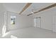 Bedroom features exposed ceiling beams, neutral carpet, and a sliding barn door at 543 Allessandra Dr, Clayton, NC 27527