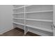 A walk-in closet with built-in shelves and hardwood floors at 543 Allessandra Dr, Clayton, NC 27527
