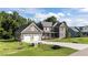 Charming home showcasing a well-kept lawn and a long driveway leading to the garage at 543 Allessandra Dr, Clayton, NC 27527