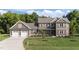 Beautiful two-story home featuring a three-car garage and a well-manicured lawn at 543 Allessandra Dr, Clayton, NC 27527