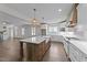 Expansive kitchen featuring a large island, stainless appliances, pendant lighting, and seamless flow into the living area at 543 Allessandra Dr, Clayton, NC 27527