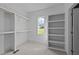 Spacious walk-in closet with built-in shelving, natural light, and neutral carpet at 543 Allessandra Dr, Clayton, NC 27527