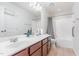 Bright bathroom featuring a double sink vanity, large mirror, and a shower-tub combo at 543 Callandale Ln, Durham, NC 27703
