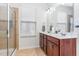 Bathroom featuring double sink vanity, walk in shower, and updated tile floors at 543 Callandale Ln, Durham, NC 27703
